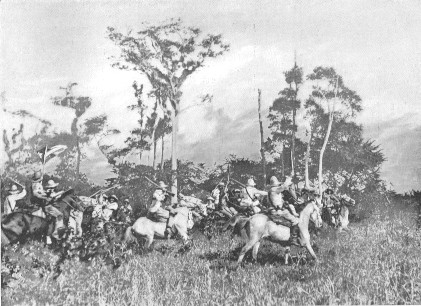CUBAN CAVALRY CHARGING SPANISH GUERILLAS ON THE OUTSKIRTS OF PUERTO PRINCIPE.